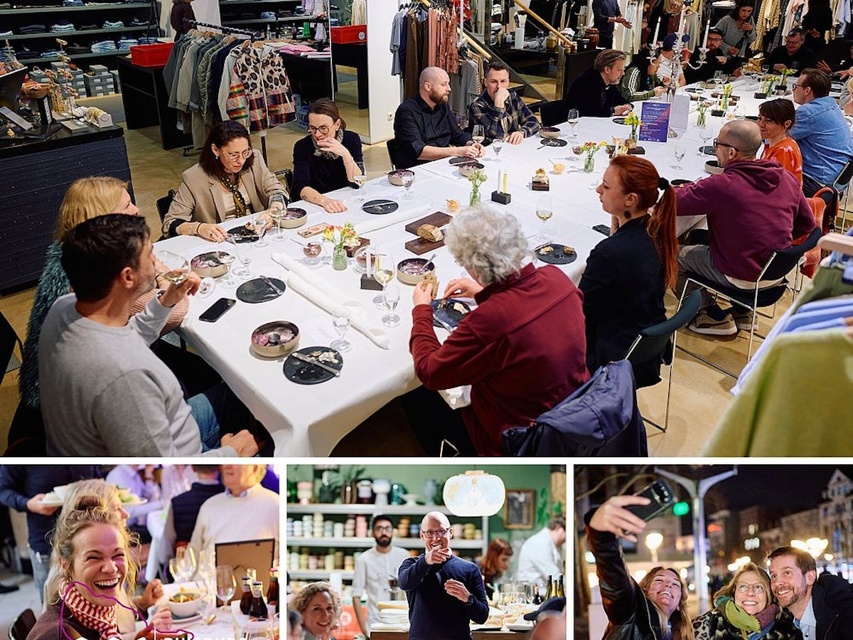 Eine große Gruppe speist an einem langen Tisch in einem stilvollen Geschäft; kleinere Bilder darunter zeigen Menschen, die bei einer festlichen Veranstaltung lachen, essen und Selfies machen. Im Hintergrund sind Kleiderständer und Regale zu sehen.